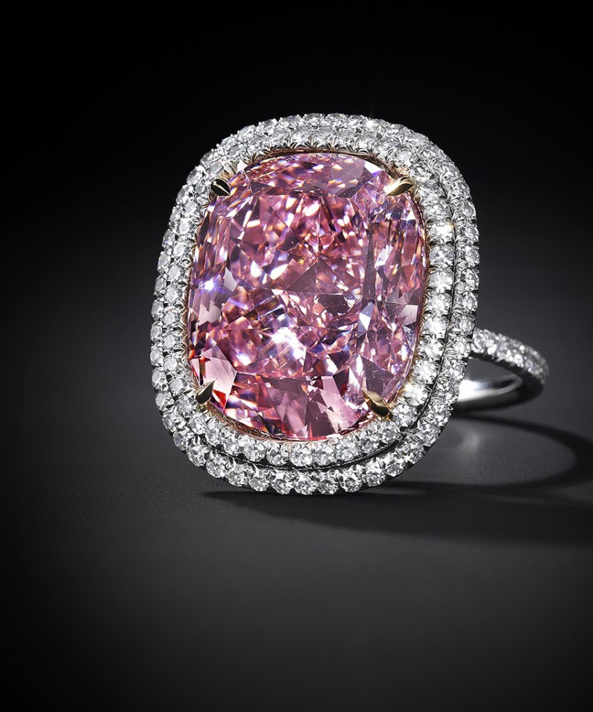 In this undated photo provided by Christies Auction House in New York, a 16.08 carat, a pink diamond the size of a postage stamp is shown in a ring setting. It could set a record for a cushion-shaped fancy vivid pink diamond when its offered Christies at its Magnificent Jewels sale in Geneva on Nov. 10, where it is estimated to bring as much as $28 million. (Antfarm Photography/Christies Auction House via AP)