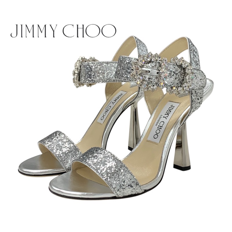 投稿記事「ジミーチュウ Sereno 100 グリッター レザー ビジュー アンクルストラップ メタルヒール サンダル グレーを買取しました！」の商品画像